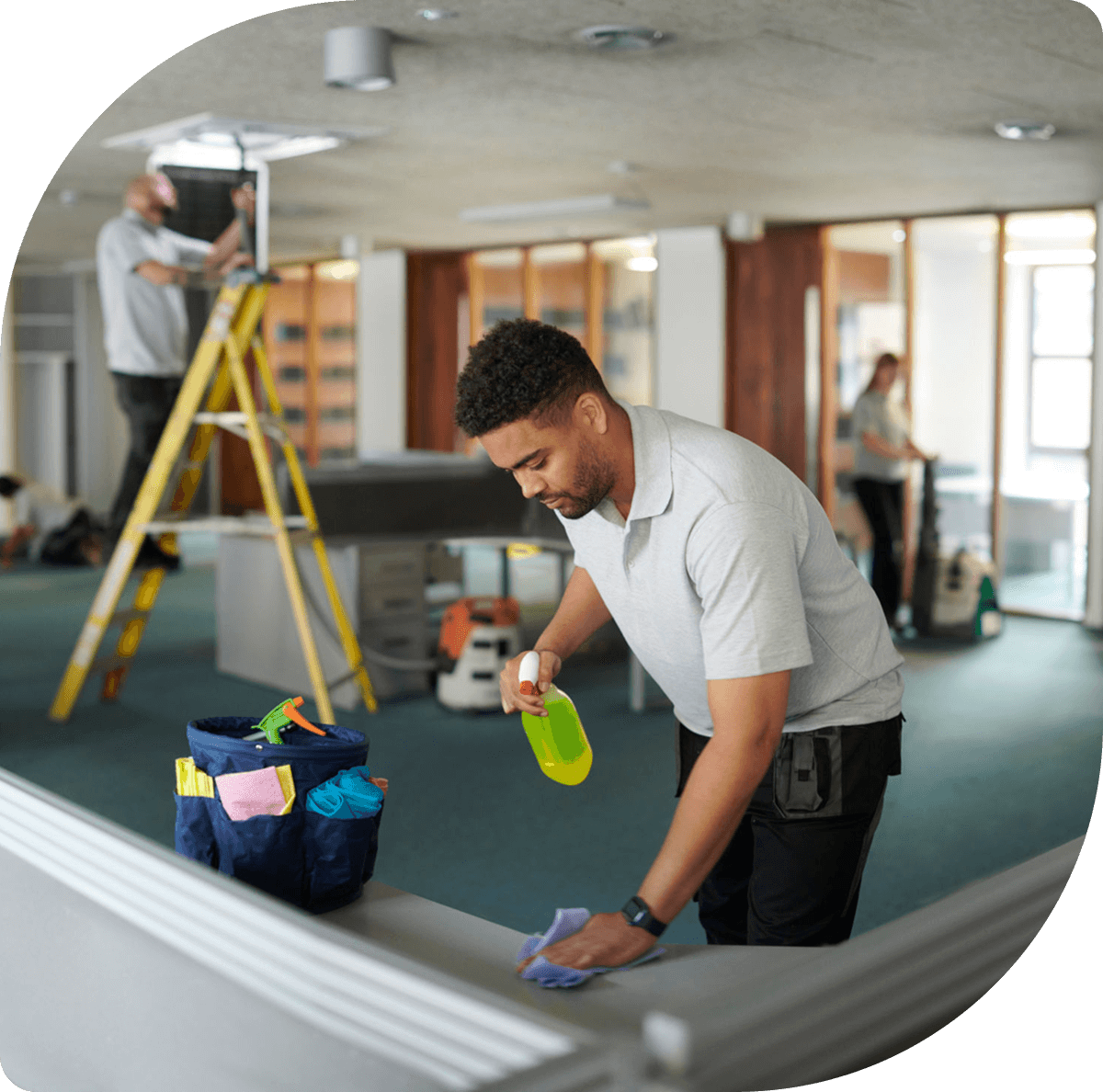 Man cleaning desk in office environment