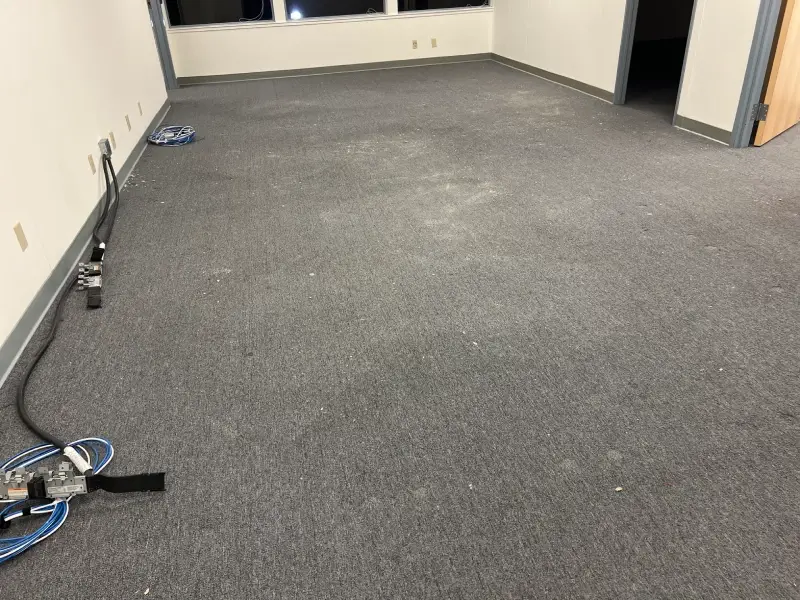 Empty room with gray carpet and white walls.